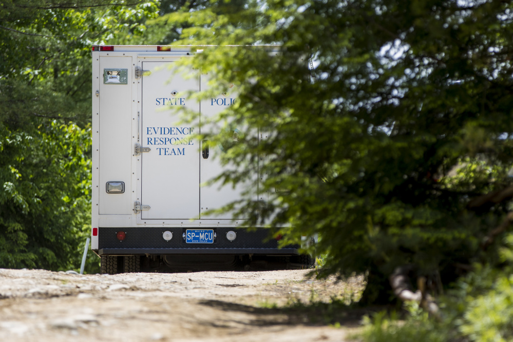 A Maine State Police truck sits parked outside 540 Ossipee Trail in Limington at the scene of a homicide investigation Sunday.