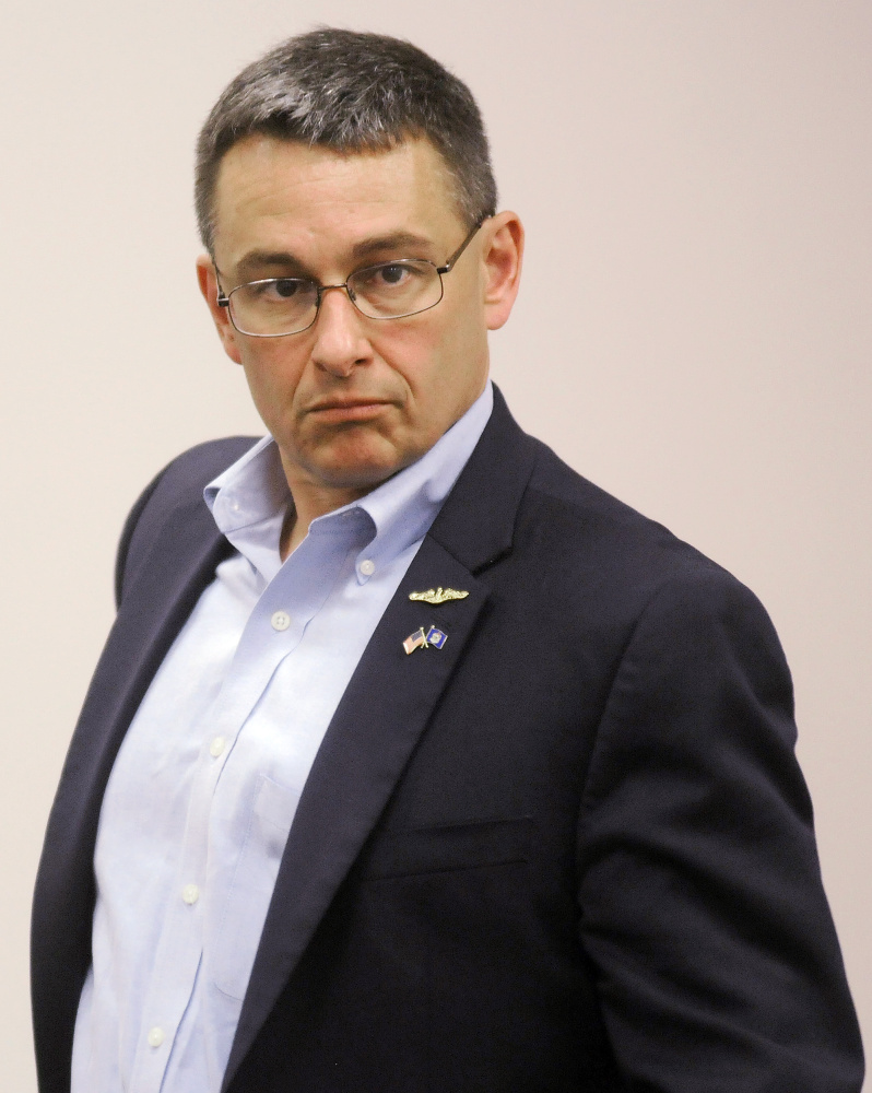 Ande Smith monitors the recount Tuesday in Augusta.  Smith requested the recount after unofficial results showed him losing to Mark Holbrook by 55 votes.