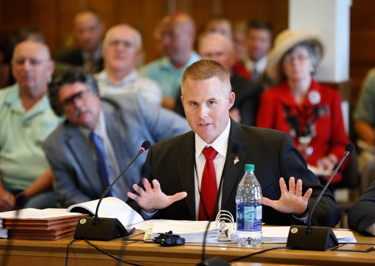 Col. Joel Wilkinson, chief of the Maine Warden Service, answers questions during a legislative meeting Wednesday about the conduct of Maine game wardens during undercover poaching investigations, at the State House in Augusta.