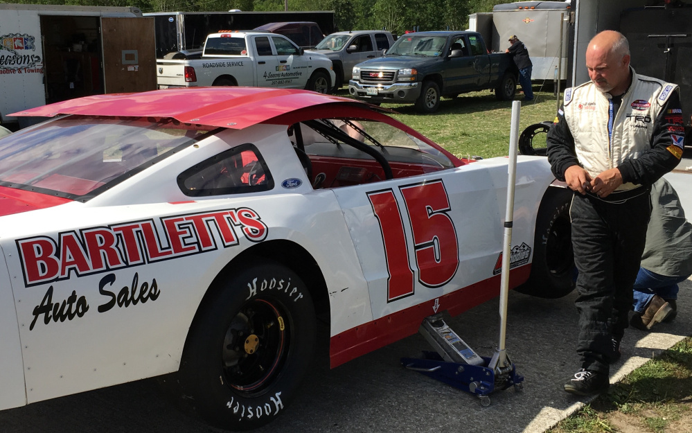 Scott Chubbuck of Bowdoin looks over his car in the pit area at Wiscasset Speedway on Saturday.