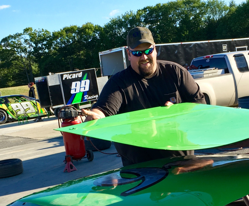 Seven-time Wiscasset Speedway street stock champion Maurice Young of Chelsea works on a car Saturday in the track's pit area.