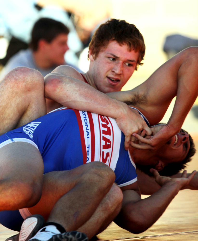 Winslow High School's Ryan Fredette, top, battles Nebraska's Patrick Ondrak during the 35th annual Maine-Nebraska wrestling exchange held Saturday in the Hight Chevrolet parking lot in downtown Skowhegan.