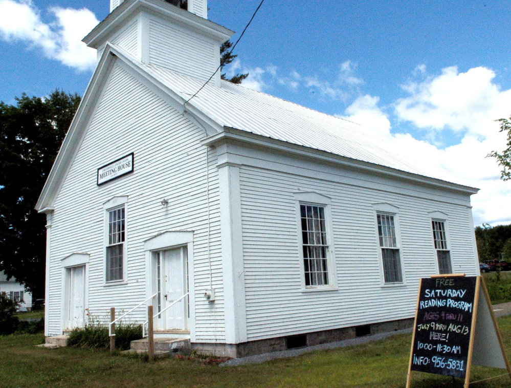 A sign at the Chesterville Center Union Meeting House promotes the Chesterville summer reading program, which town organizations hope is a first step toward getting a library in the town.