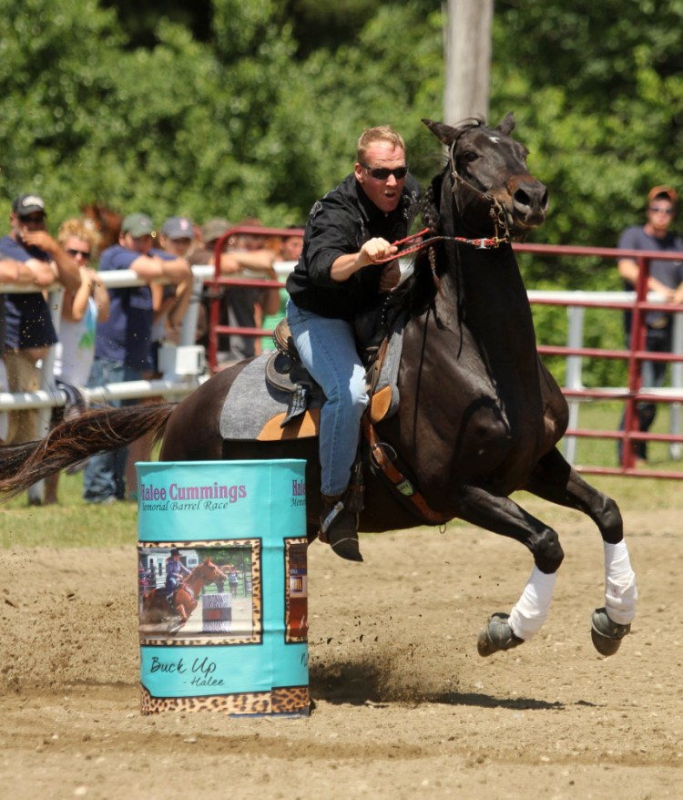 Hardy Cummings rides his horse Sin at the Halee Lyn Cummings Memorial Barrel Race at the Silver Spur Riding Club in Sidney on Sunday to honor his late daughter. Halee Cummings, 18, of Sidney, died in an ATV accident last year.