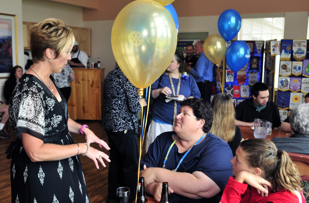 Lynn Ouellette, left, and Christine Devine chat as her daughter Jordan Devine listens on Friday during the Augusta Rotary Centenary celebration at the Cohen Center in Hallowell.