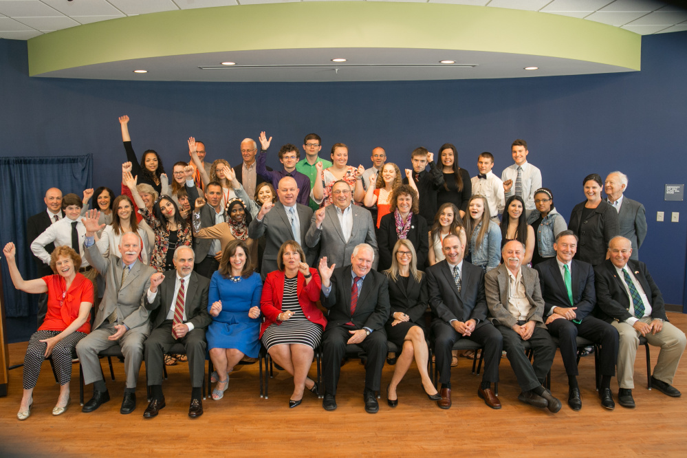 JMG students celebrate completing the very first JMG Summer Academy session at Thomas College  with Gov. Paul LePage, JMG CEO Craig Larrabee, Thomas College President Laurie Lachance, Education Commissioner Bill Beardsley, Labor Commissioner Jeanne Paquette, Health and Human Services Commissioner Mary Mayhew, Greg Powell, board Chairman of Harold Alfond Foundation; Tony Cipollone, president and CEO of John T Gorman Foundation; Larry Sterrs, chairman and CEO of Unity Foundation; Wendy Ault, executive director of MELMAC Education Foundation; Maj. Gen. Bill Libby; Walter Corey, president, Maine Leadership Institute; and Kim Lipp, executive vice president, JMG.