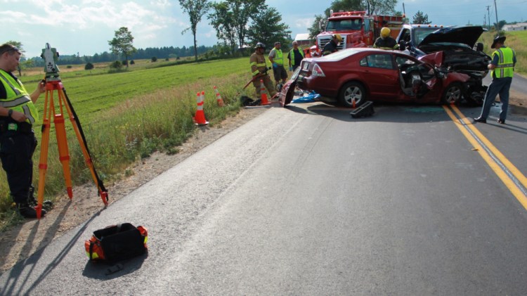 Authorities investigate the scene of an accident Wednesday afternoon on Route 137 in Knox. The crash killed Shannon Kennedy, of Unity. Kennedy's car crossed into the oncoming lane and struck a pickup truck head-on, police said.