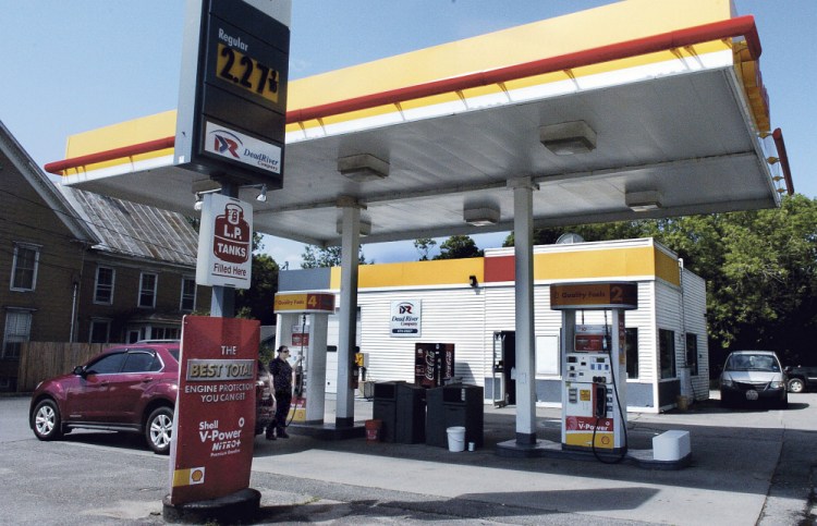 Dead River Co. employee Melony Thomas pumps gasoline for a customer at the Skowhegan Shell station on Monday, a few hours after the store was reportedly robbed.
