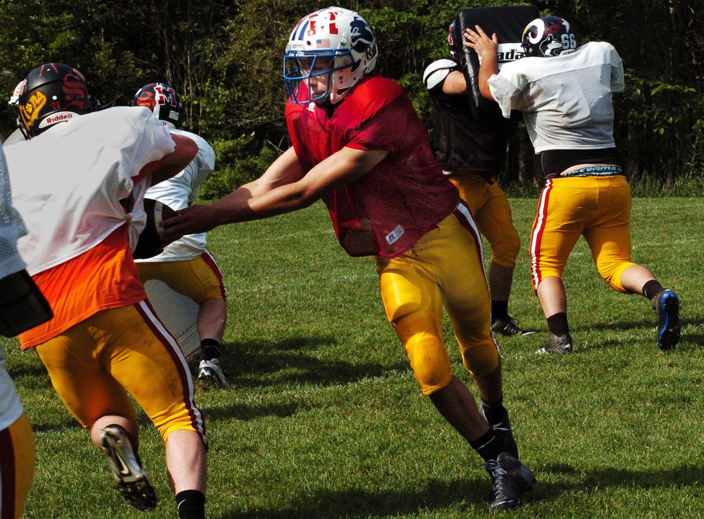 East team quarterback Chase Malloy, of Madison, participates in a drill during a Maine Shrine Lobster Bowl practice Tuesday during training camp at Dover-Foxcroft.