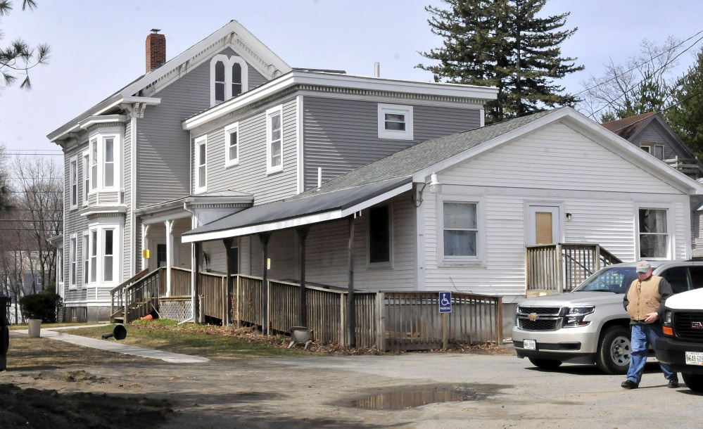 State fire marshal's office investigator Ken MacMaster prepares in April to enter Motivational Services at 73 Pleasant St. in Waterville after a fire. A woman who had been a resident of the home, Jean Rowe, was in court Wednesday facing two class A felony arson charges in connection with the fire.