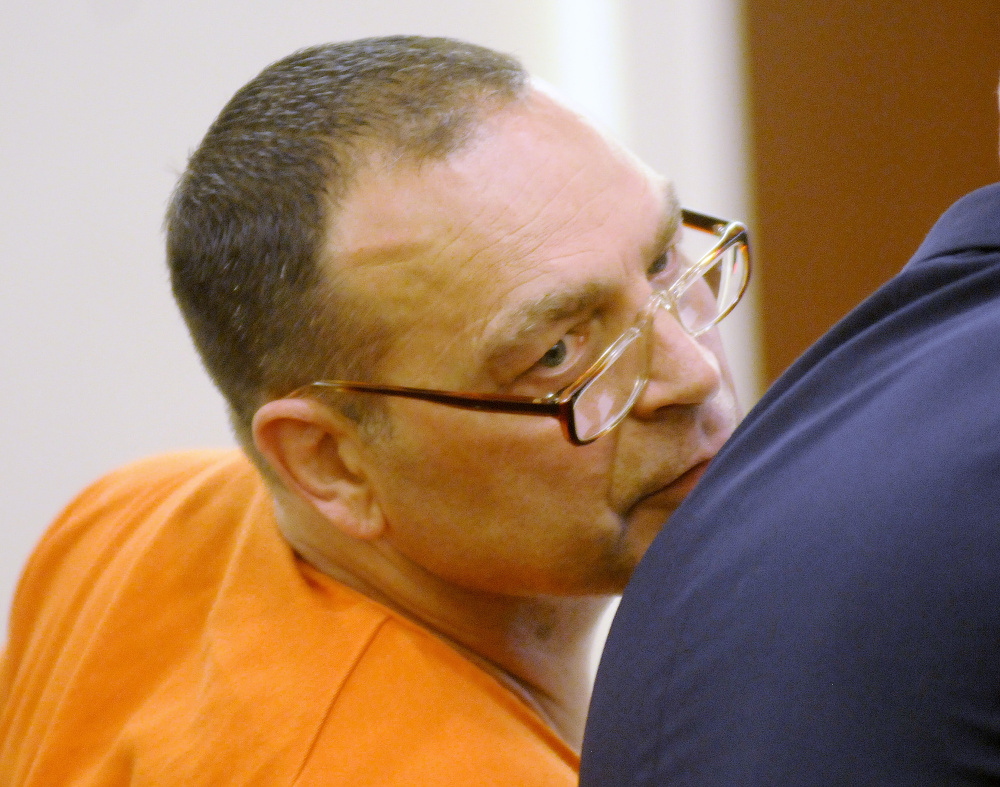 Raymond Bellavance, convicted in 2011 of burning down the Grand View Topless Coffee Shop in Vassalboro, speaks Wednesday with an attorney during a hearing for a new trial during at the Capital Judicial Center in Augusta.