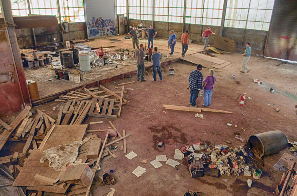 The large metal building on south side of Summer Street in Gardiner, shown here in May during an auction at the former T.W. Dick facility, is one of the blighted properties that would be torn down by a developer as part of a project intended to revitalize the area.
