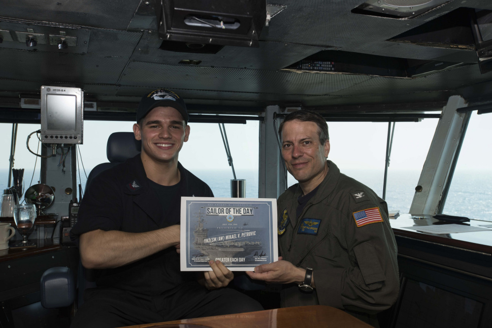 Petty Officer 2nd Class Mikael Petrovic, of Winslow, Maine, and a 2013 graduate of Winslow High School, was recently awarded Sailor of the Day aboard USS Dwight D. Eisenhower in the Mediterranean Sea by Commanding Officer, Capt. Paul C. Spedero Jr. Petrovic received the award as the only yeoman serving 600 personnel with the Carrier Air Wing Three (CVW-3)  embarked on the ship. Petrovic enlisted in the Navy in Aug. 15, 2013, and is being screened for the Chief of Naval Operations Staff in Washington, D.C.  He is the son of Robert and Jacquelyn Petrovic, of Winslow.