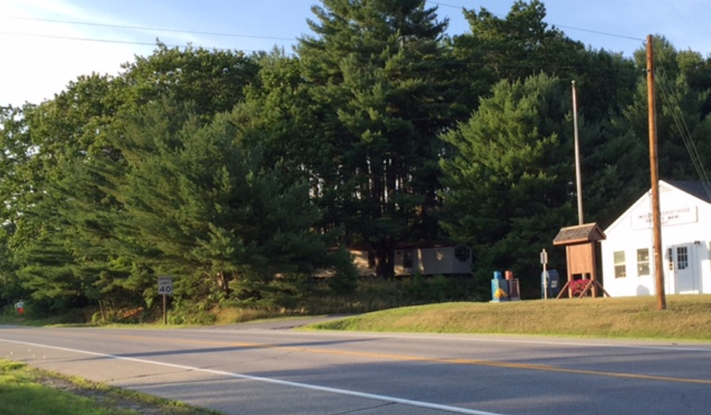 An application for approval of plans for a Dollar Store to be built on the lot between the post office, right, and Town Office, entrance far left, on Route 27, have been withdrawn temporarily. A project manager for the engineering firm working on the project has acknowledged that the application is incomplete.