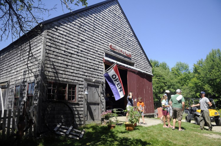 Ron DiGravio, right, escorts guests through the barn at Cranberry Rock Farm in Winthrop during Open Farm Day on Sunday.