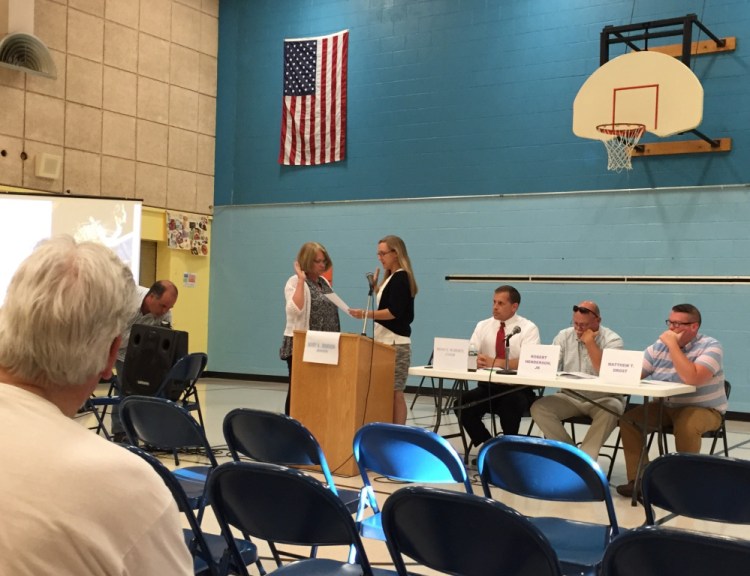 Randolph Town Clerk Lynn Mealey swears in moderator Mary Denison at the start of Wednesday's Town Meeting.