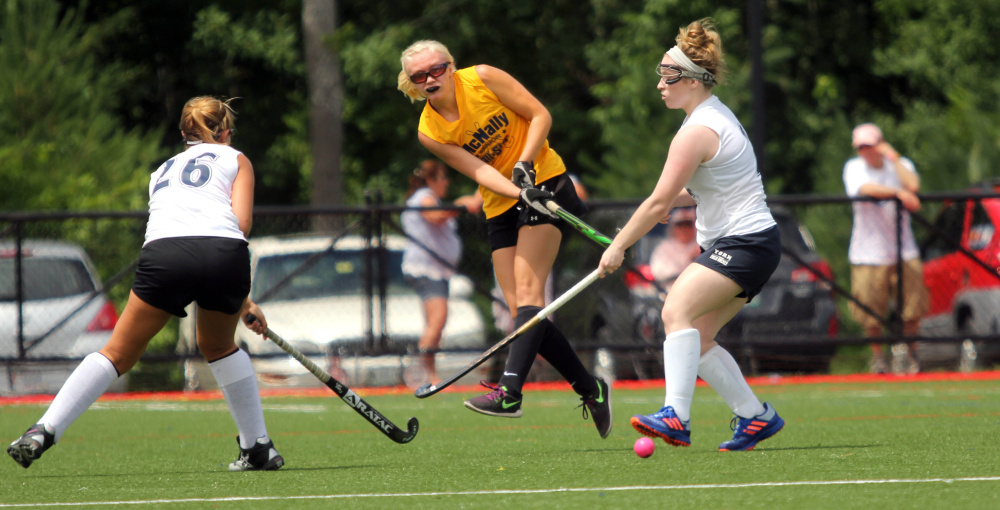 Maine Central Institute's Taylor Hall, playing for the North, passes the ball by the South's Kylee Veilleux (26) of Oak Hill and Devon Datsis of York at the McNally Senior All-Star game Saturday at Thomas College in Waterville.