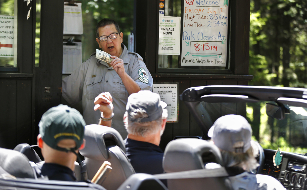 Sarah Crosby collects entrance fees at Reid State Park in Georgetown. Crosby has worked the forested entryway to Maine's oldest state-owned beach since 1972.