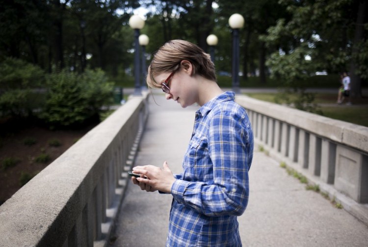 Anna Simmons of Portland spends some time in "augmented reality" at Deering Oaks park.