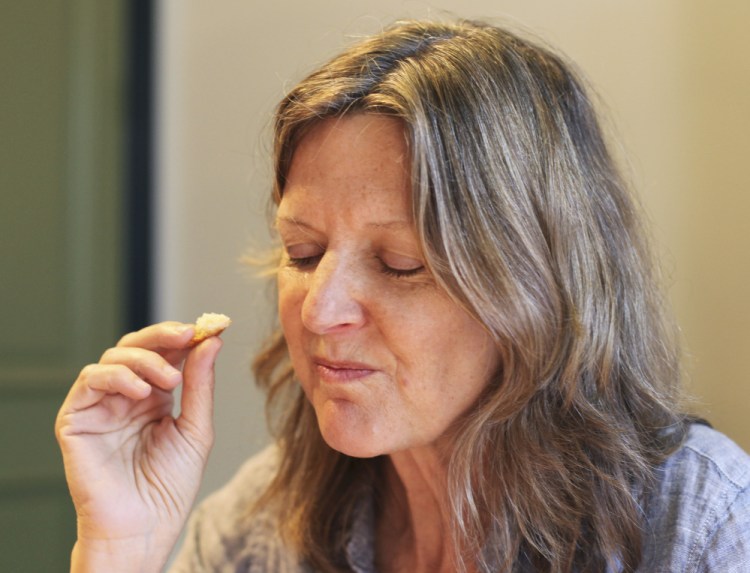 Alison Pray, co-owner of Standard Baking Co., inhales the scent of a demi-baguette while using a tasting chart developed by Michael Kalanty.
