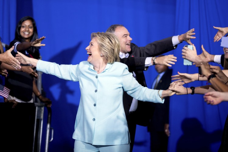 Democratic presidential candidate Hillary Clinton and Sen. Tim Kaine, D-Va., arrive together at a rally at Florida International University Panther Arena in Miami on Saturday. Clinton has chosen Kaine to be her running mate.