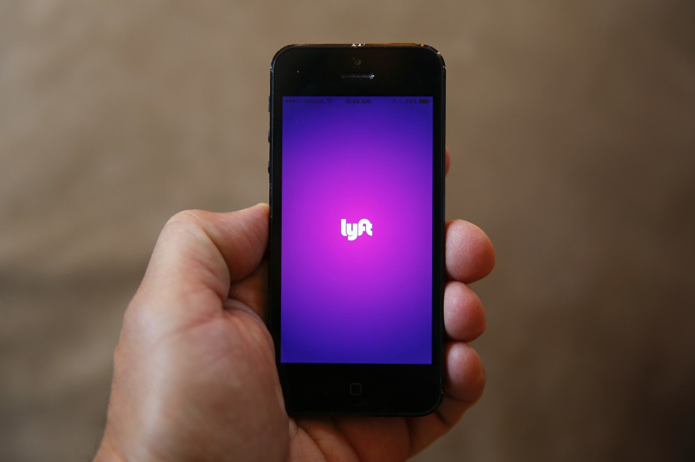 A smartphone displays the Lyft app. The ride-sharing service has been advertising for drivers in Portland.
