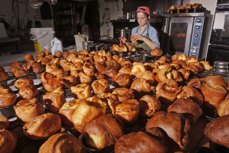 Jessica Stewart pulls popovers out of baking pans at the Common Good Soup Kitchen & Cafe. 