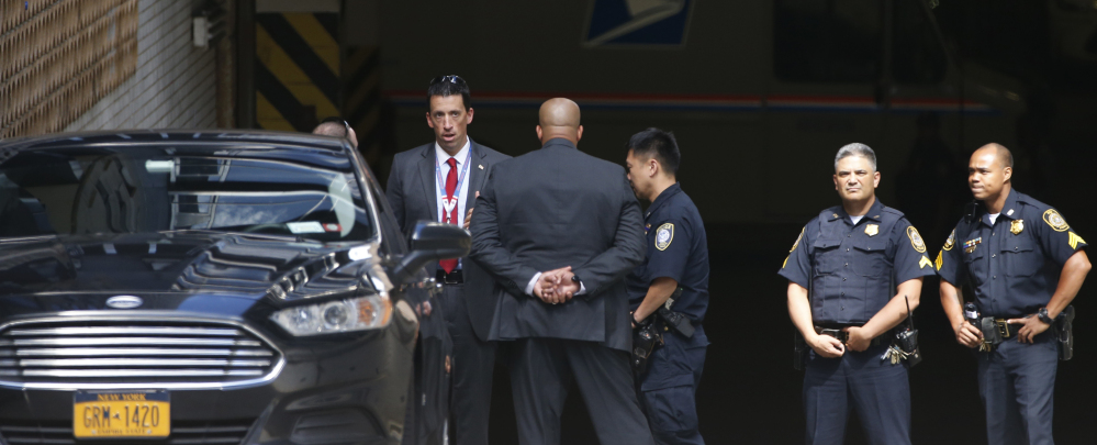 Police and security for Donald Trump gather Wednesday in a parking garage beneath the Jacob K. Javits Federal Building in Lower Manhattan in New York.