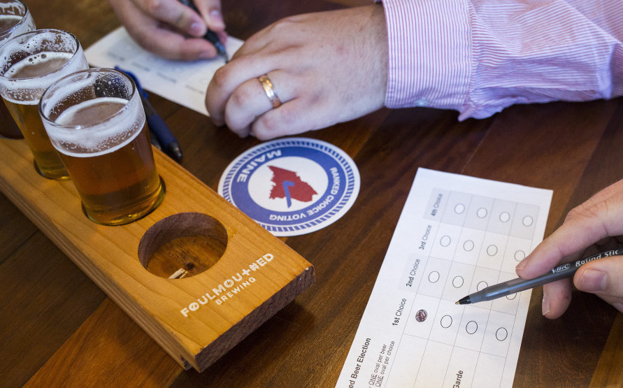 Finn Melanson, a volunteer with the League of Women Voters, ranks his beer choices in a demonstration at Foulmouthed Brewing in South Portland.