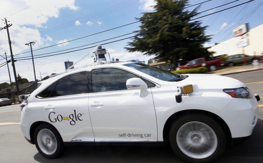 FILE - In this May 13, 2015, file photo, Google's self-driving Lexus drives along a street during a demonstration at Google campus in Mountain View, Calif. While the Boston region is a center for robotics and artificial intelligence research, none of the Northeast states allows self-driving cars to be driven or tested on public roads. But Massachusetts officials are looking in 2016 at turning part of the former Devens military base into a self-driving testing ground. (AP Photo
