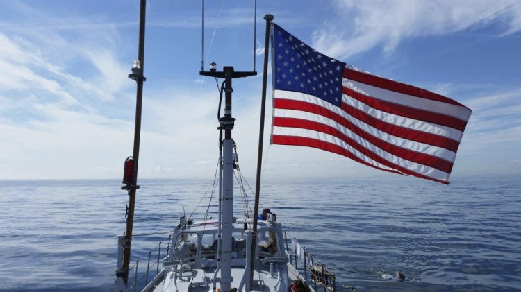 A support boat accompanies Pat Gallant-Charette of Westbrook, in the water at right, as she swims the North Channel of the Irish Sea between Northern Ireland and Scotland. The 21-mile crossing took 14 hours and 22 minutes and left her with jellyfish stings "over every inch of my body."
