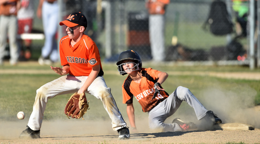 Skowhegan's Payson Washburn (18) slides into second base before Marlboro, Massachusetts second baseman Austin Hunt can make the tag in the 11U Cal Ripken New England tournament Wednesday at the Carl Wright Complex in Skowhegan.