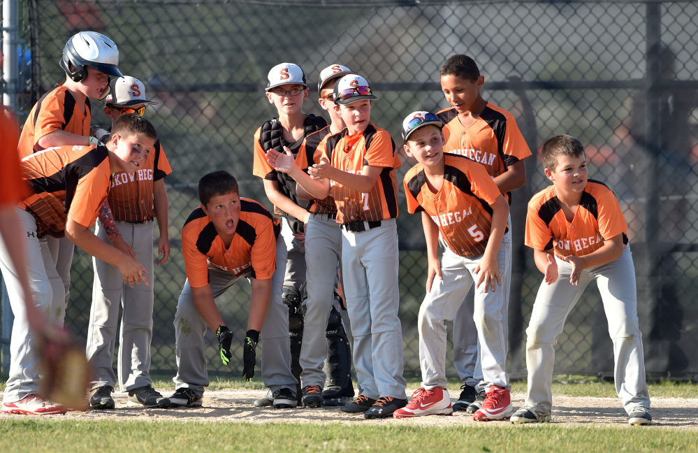 Skowhegan teammates wait at home plate to celebrate Simon Lewis' home run against Marlboro, Massachusetts in the 11U Cal Ripken New England tournament Wednesday at the Carl Wright Complex in Skowhegan.