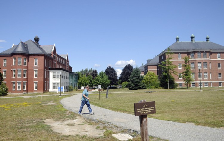 A man walks at the state office complex on the east side of Augusta Monday. The Augusta Planning Board on Tuesday will consider a request by the state to expand the parking area at the complex.