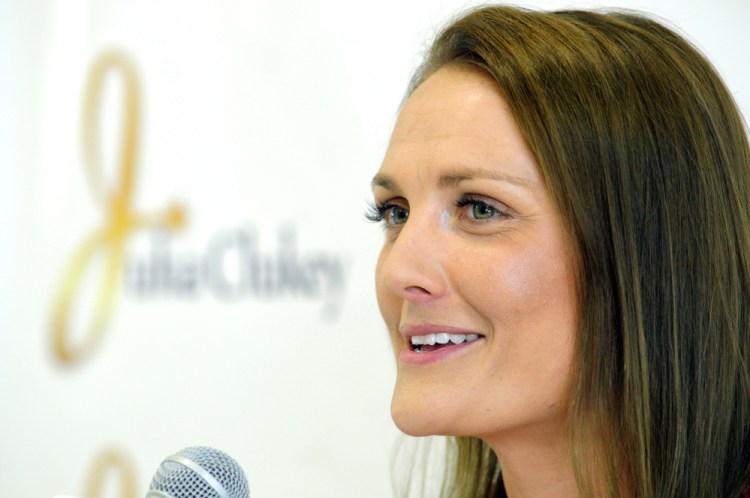 Julia Clukey, of Augusta, announces her retirement from luge during a news conference Tuesday at the Kennebec Valley YMCA in Augusta.