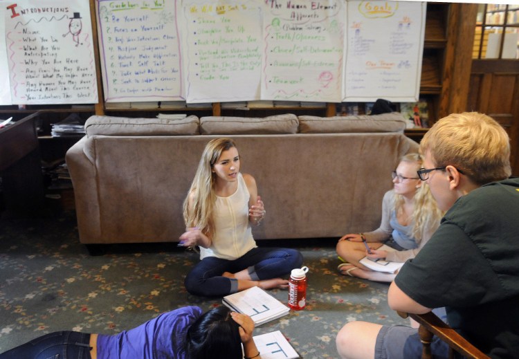 Gardiner Area High School alumnus Josh Mathews, right, and seniors Brynne Austin, Sierra Goodridge and Erin Qiu discuss the Human Element Seminar leadership course Wednesday at the Gardiner Public Library.