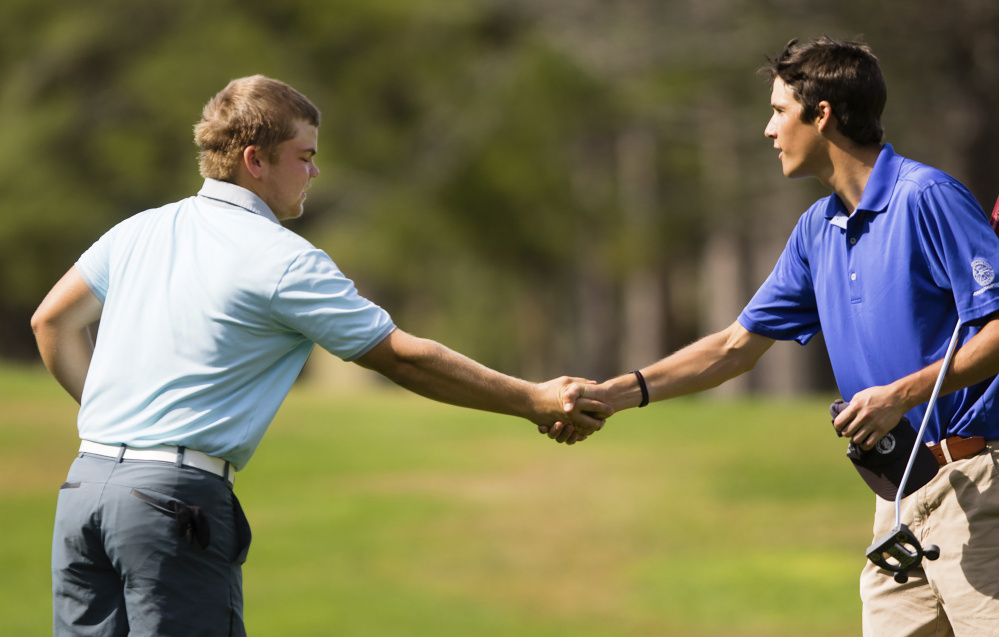 Matt Hutchins, left, is congratulated by Will Kannegieser after winning the Maine Match Play Championship on Thursday at the Brunswick Golf Club.