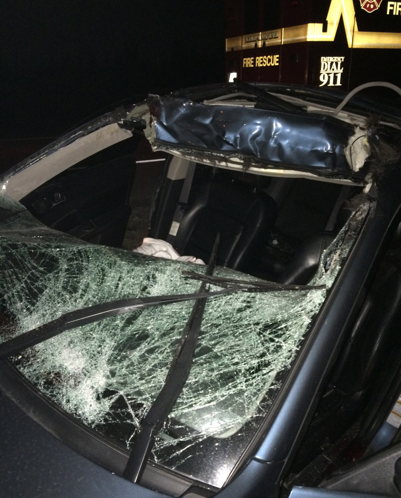 A Subaru Legacy driven by  John Coyle shows the damage after he hit a moose on U.S. Route 201 Saturday night. Coyle was in critical condition at Central Maine Medical Center in Lewiston Monday.