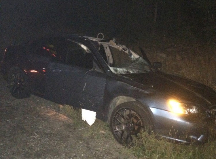 A Subaru Legacy driven by John Coyle shows the damage after he hit a moose on U.S. Route 201 Saturday night. Coyle was in critical condition at Central Maine Medical Center in Lewiston Monday.