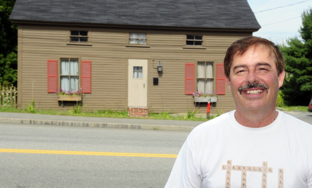 Larry Fleury stands beside 25 Bond St. on Thursday in Augusta, a property he bought for $1, renovated and is now offering for sale for $72,000.
