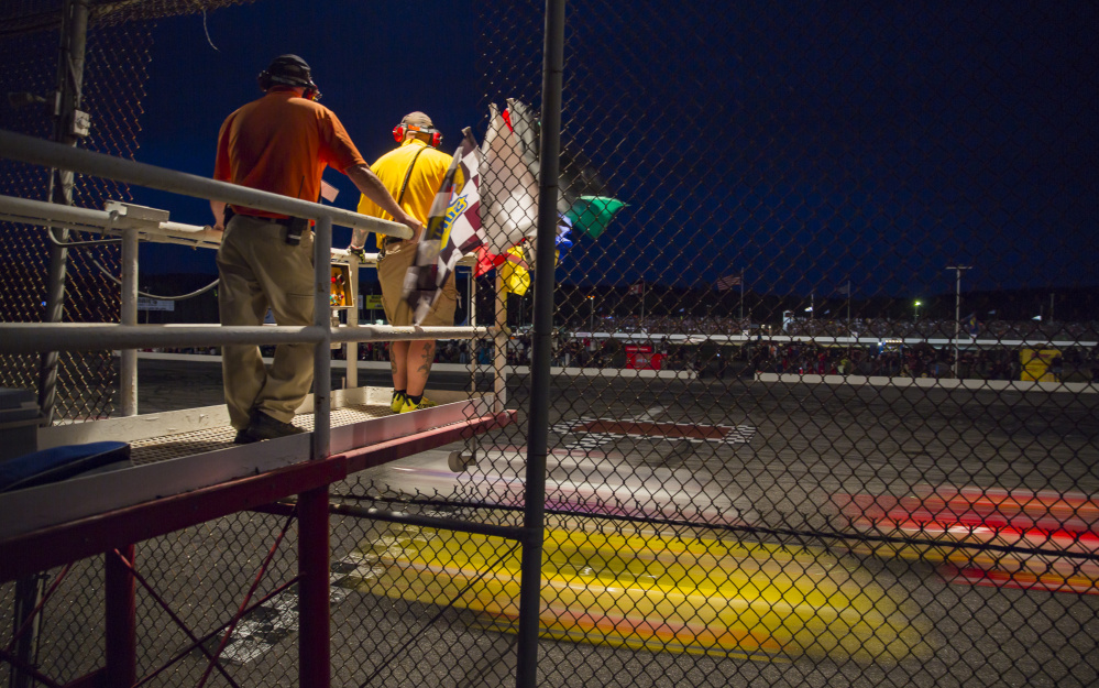 Race officials stand on a platform at the finish line during the Oxford 250.