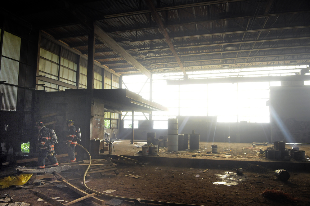 Gardiner firefighters extinguish a blaze Monday inside the former T.W. Dick Co. iron works on Summer Street in Gardiner.