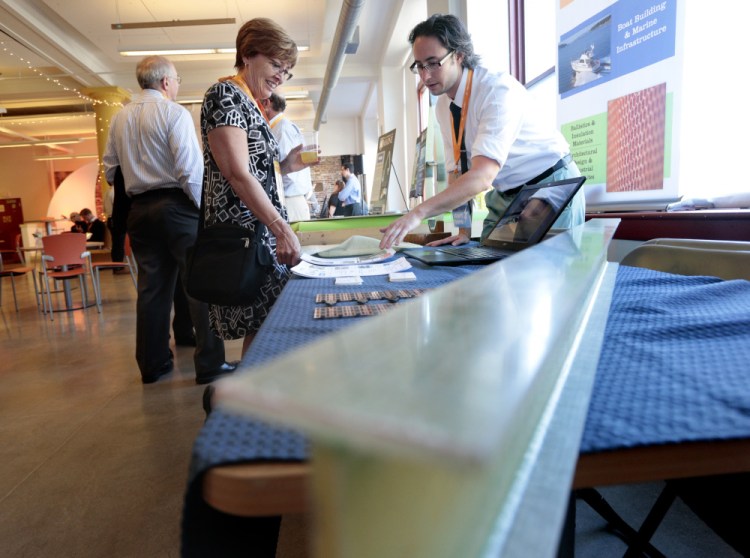 Susan Hodder of Comprend Consulting talks with Benjamin Brown of The Maine Composites Alliance at a "mixpo" at Maine College of Art as part of Maine Startup and Create Week 2016.