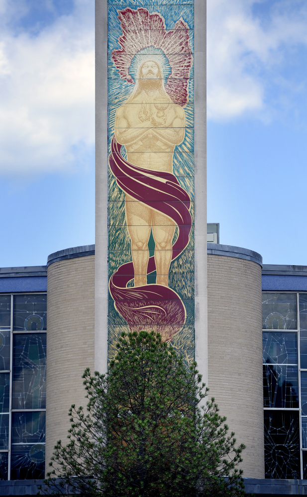 The pine that obscures the mural of Jesus Christ on Holy Cross Catholic Church has started to turn green again.