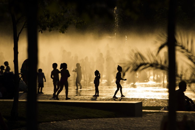 Children play as they cool down in a fountain beside the Manzanares river in Madrid, Spain, in 2015. Earth's fever got worse last year, 450 international scientists diagnosed in a massive report nicknamed the annual physical for the planet.
