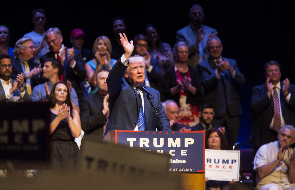 Donald Trump acknowledges applause Thursday during his speech at Merrill Auditorium. On immigration, he said the refugees admitted by the U.S. are "coming from among the most dangerous territories and countries anywhere in the world. This is a practice that has to stop."