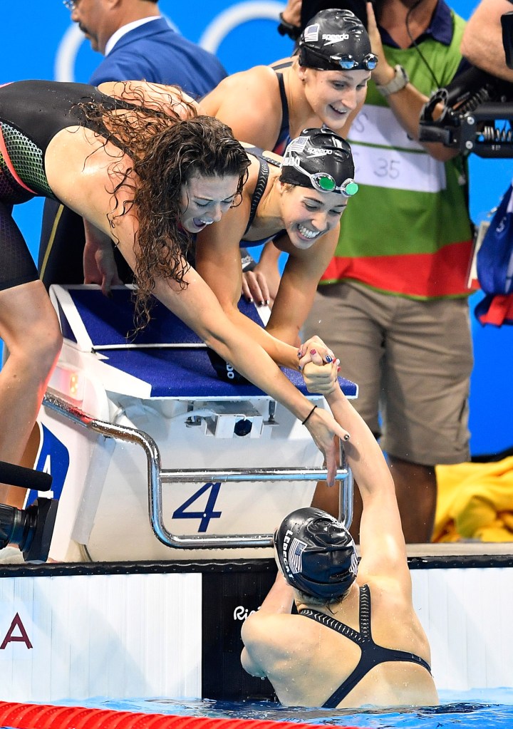 Katie Ledecky, still in the water, shakes hands with her U.S. teammates Allison Schmitt, Maya DiRado and Leah Smith, from left, after their win in the women's 4 x 200-meter freestyle relay.
Associated Press/Martin Meissner