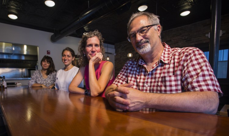 A group that is designing a food studies program for USM discusses plans over lunch at Isa Bistro on Portland Street. The effort is under the direction of Michael Hillard, right, and includes, from left, Mary-Elizabeth Simms, Jo D. Saffeir and Ali Mediate.