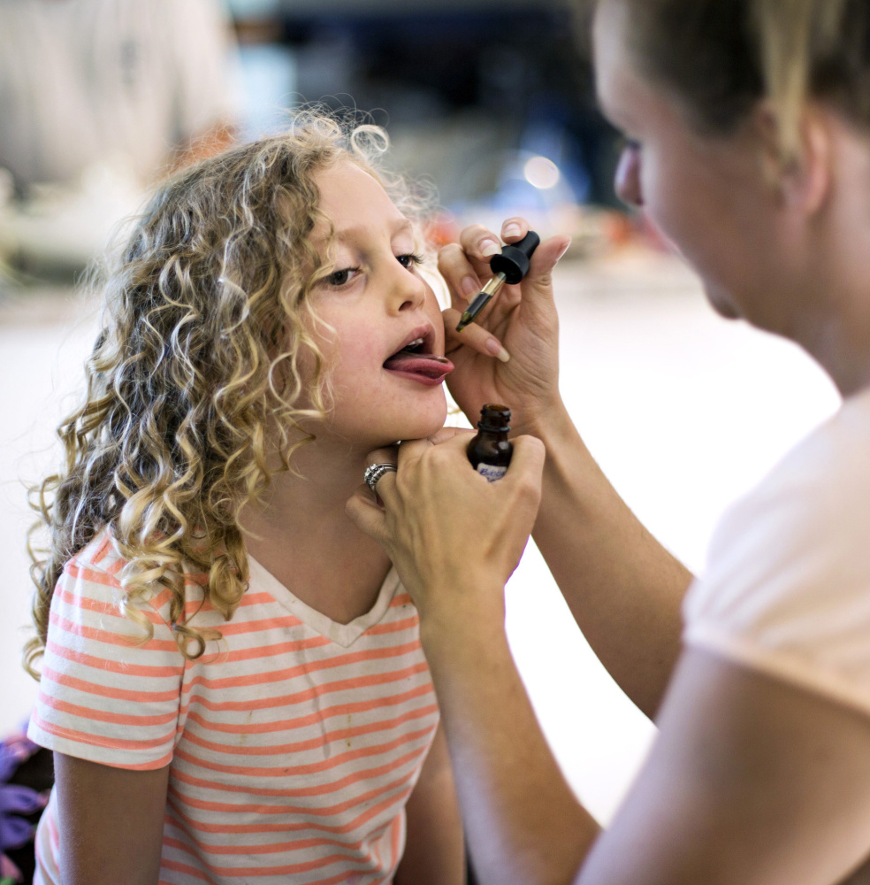 Samantha Brown of South Berwick administers a dose of cannabis oil to her 5-year-old daughter, Kaylee, a patient who requires medicinal marijuana to control seizures.