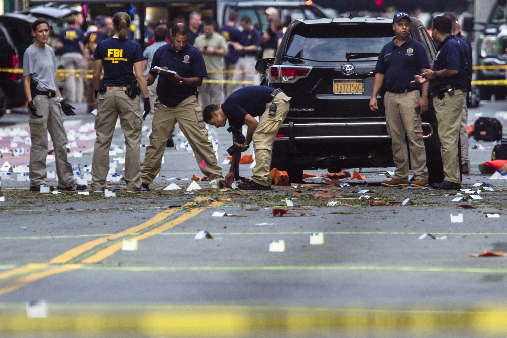 Members of the Federal Bureau of Investigation (FBI) carry on investigations at the scene of Saturday's explosion on West 23rd Street and Sixth Avenue in Manhattan's Chelsea neighborhood, New York, Sunday, Sept. 18, 2016. An explosion rocked the block of West 23rd Street between Sixth and Seventh Avenues at 8:30 p.m. Saturday. Officials said more than two dozen people were injured. Most of the injuries were minor.